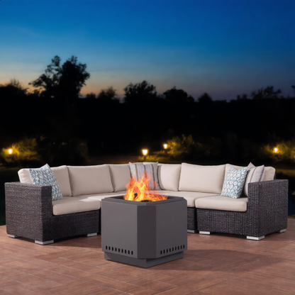 Black steel cube fire pit burning wood in the centre of a curved outdoor sofa set on a wooden deck at dusk outdoor garden fire pit Pyrova